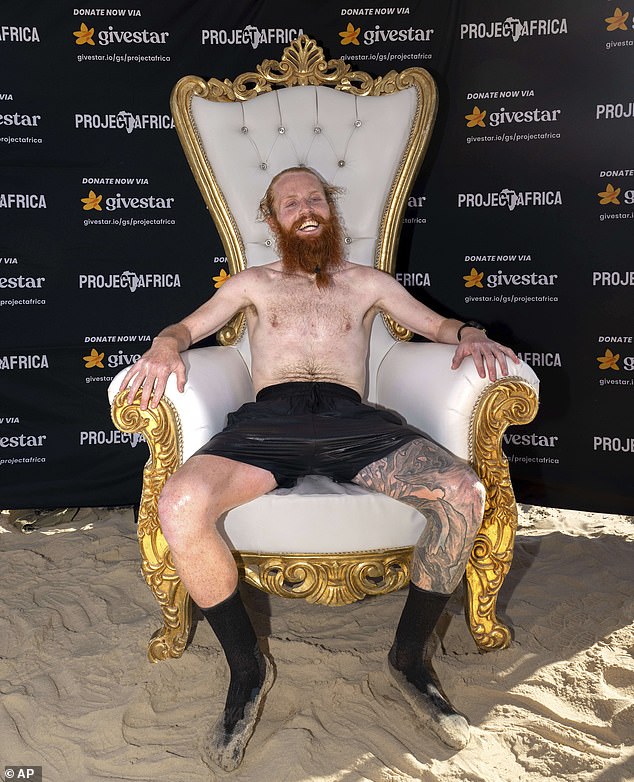 Cook sits in relief after arriving to the finish line in Ras Angela, in Tunis, Tunisia yesterday