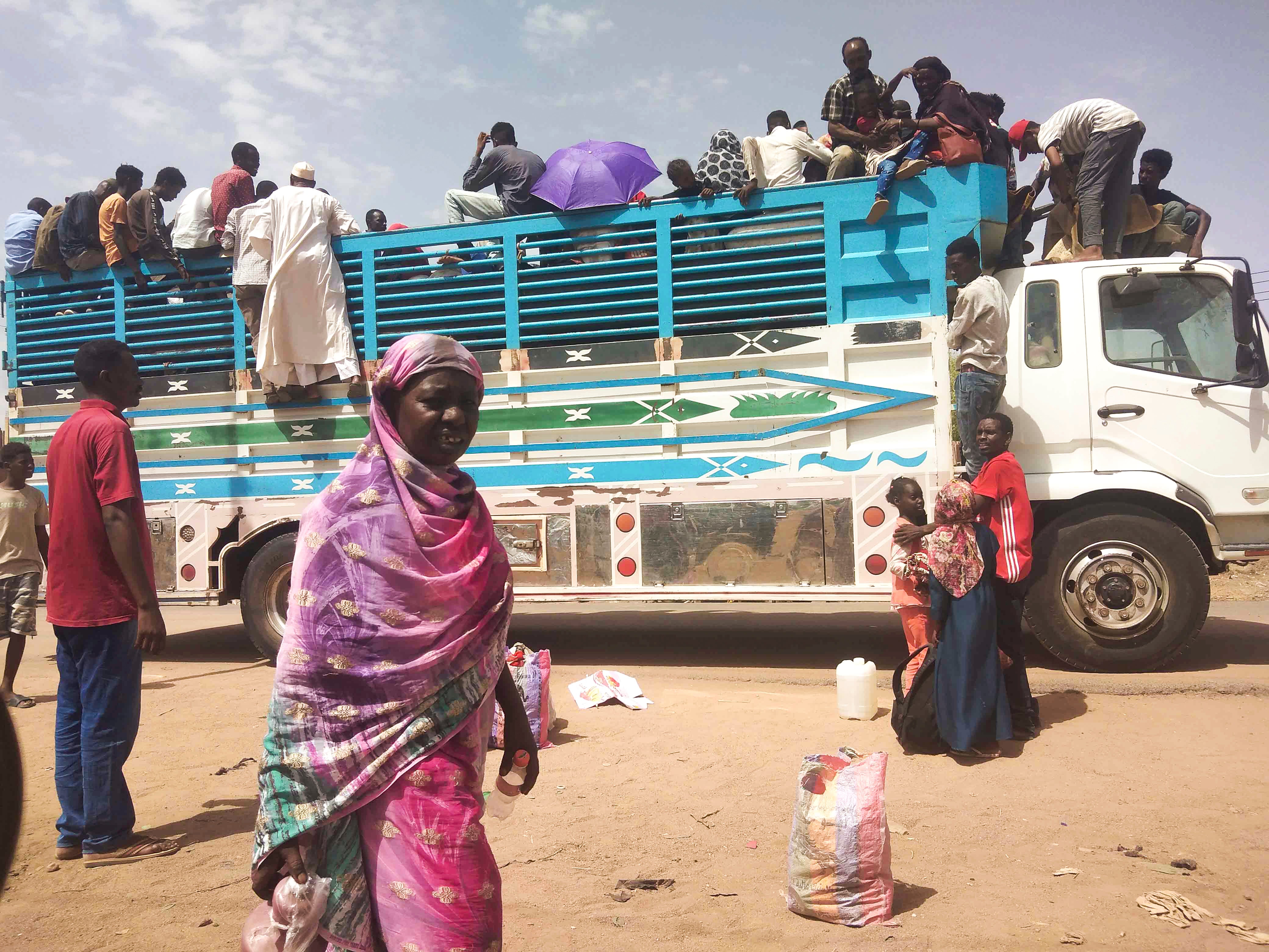 People board a truck as they leave Khartoum, Sudan, on June 19, 2023