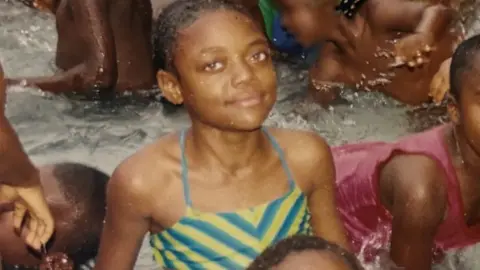 Libianca A young Libianca in a swimming pool with other children in Bamenda