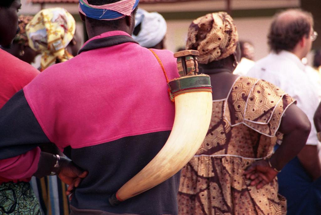 Traditional dress and an elaborate rum flask in Guinea-Bissau