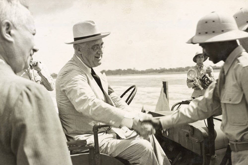 U.S. President Franklin D. Roosevelt is welcomed to the Firestone rubber plantation during a trip to Liberia in January 1943.