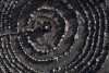 A group of Brazilian tourists hold hands standing in a circle at the heart of a stone labyrinth in the Pueblo Encanto spiritual theme park in Capilla del Monte, Argentina, Wednesday, July 19, 2023. In the pope’s homeland of Argentina, Catholics have been renouncing the faith and joining the growing ranks of the religiously unaffiliated. Commonly known as the “nones,” they describe themselves as atheists, agnostics, spiritual but not religious, or simply: “nothing in particular.” (AP Photo/Natacha Pisarenko)