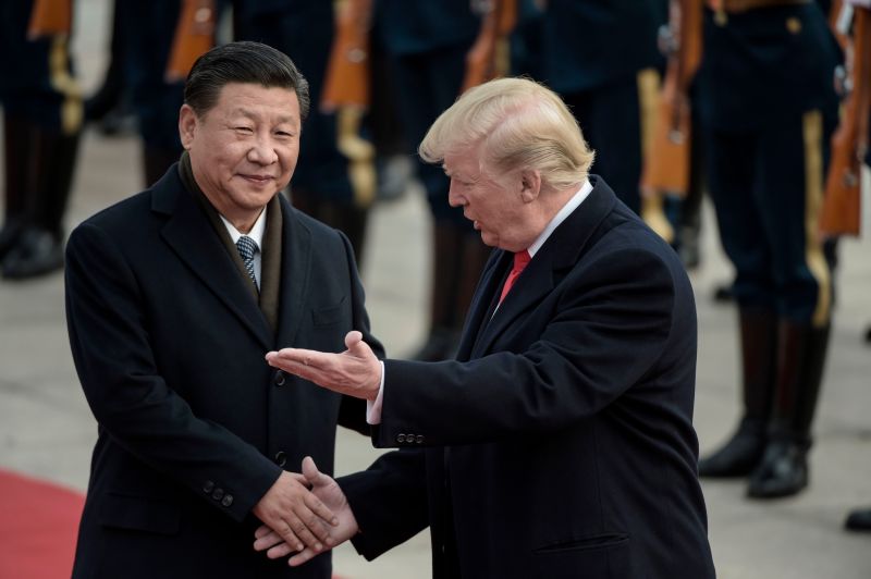 China's President Xi Jinping (L) and US President Donald Trump attend a welcome ceremony at the Great Hall of the People in Beijing on November 9, 2017.