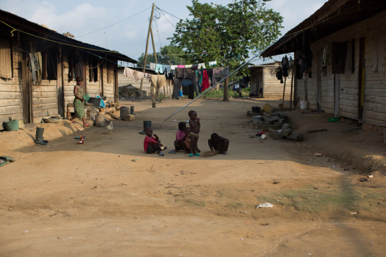 Children walk down a dirt road in Mbonjo. Image by Dylan Collins.