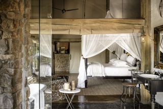 Singita Ebony Lodge Room with view of bed and basin