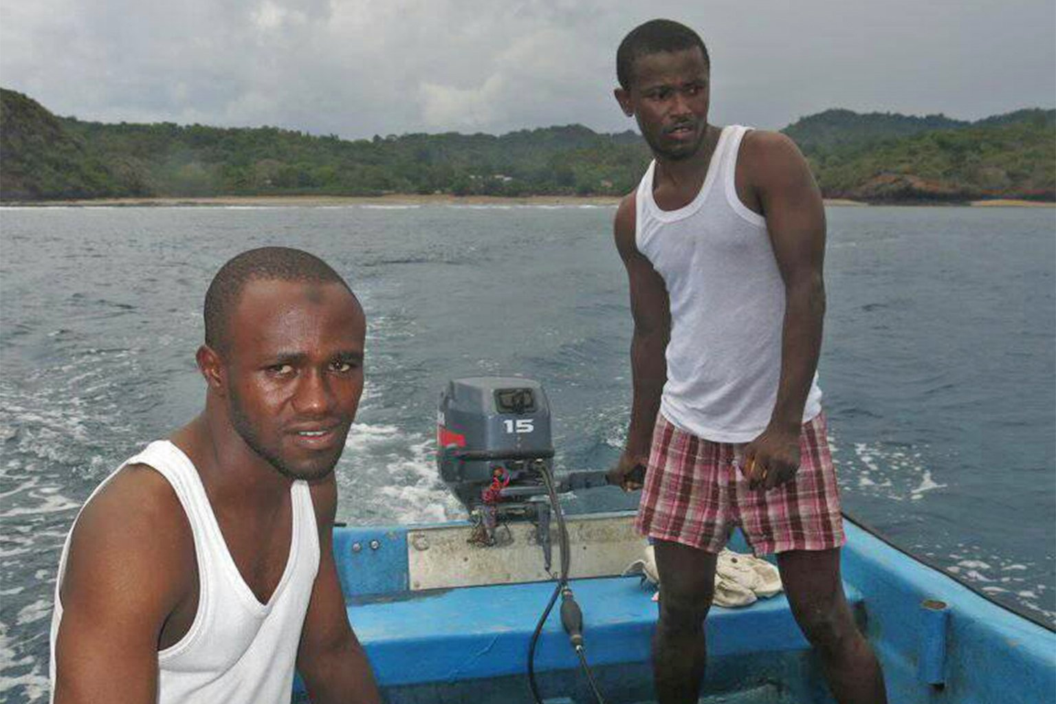 Two men set out in a boat to Mbouzi island in Itsmania.