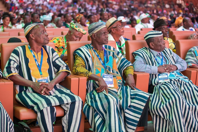 Traditional African leaders wearing striped clothing attend the 2024 Strengthening Families Conference in Abidjan, Ivory Coast.