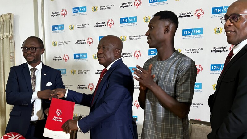 Four man stand holding a signed agreement