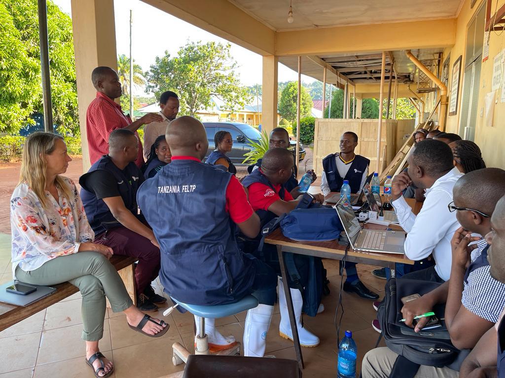 Team sitting outdoors having a collaborative work group session