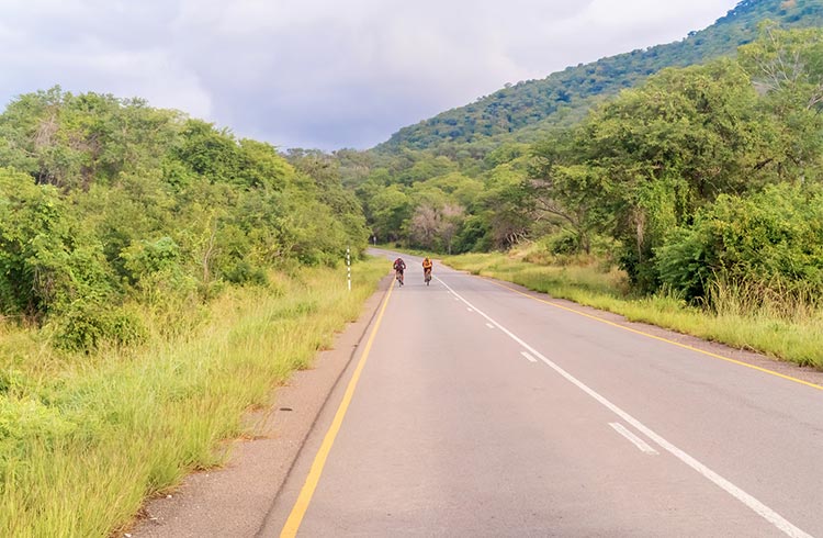 Two people riding their bicycles in Zambia