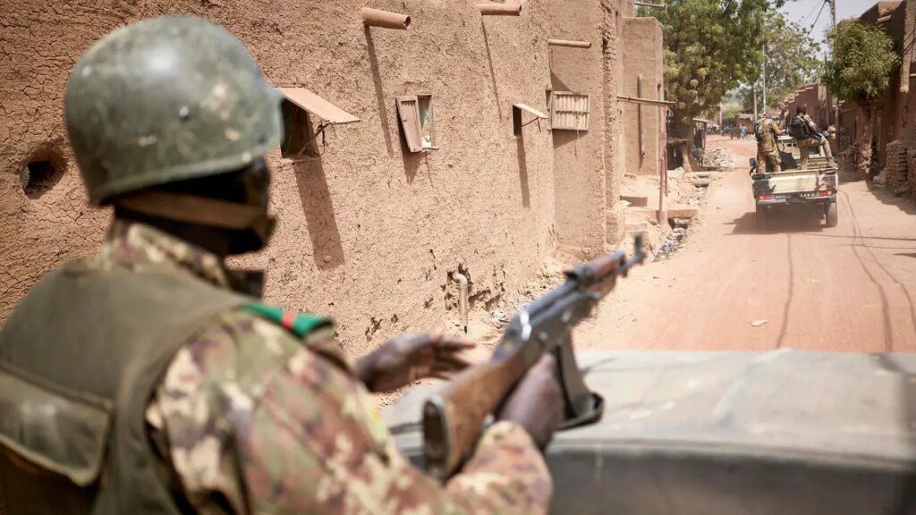 Taliban fighters stand guard near the military hospital in Kabul, Afghanistan