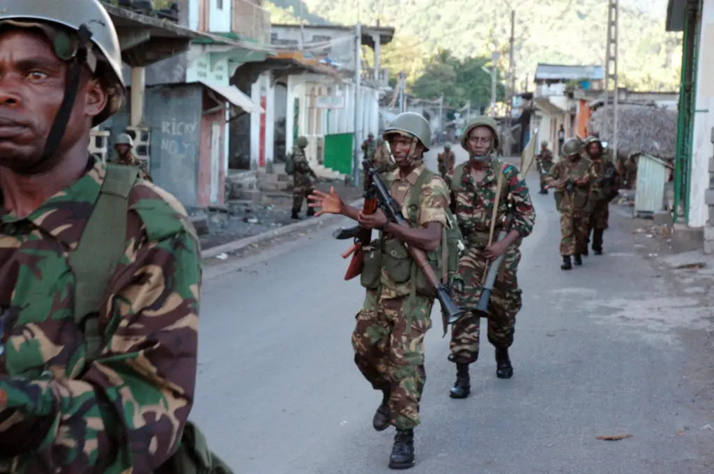 Photo of African Union troops from Tanzania and Comoran troops walking down a street in Anjouan on March 25, 2008