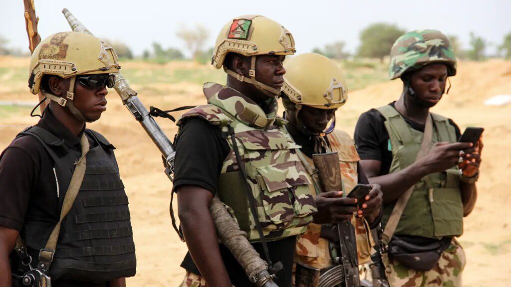 Nigerian army soldiers stand at a base