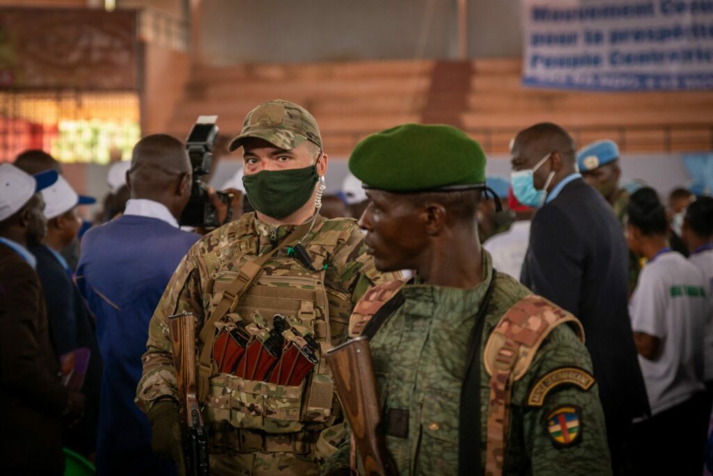 A private security guard from the Russian group Wagner stands next to a Central African Republic soldier during a rally