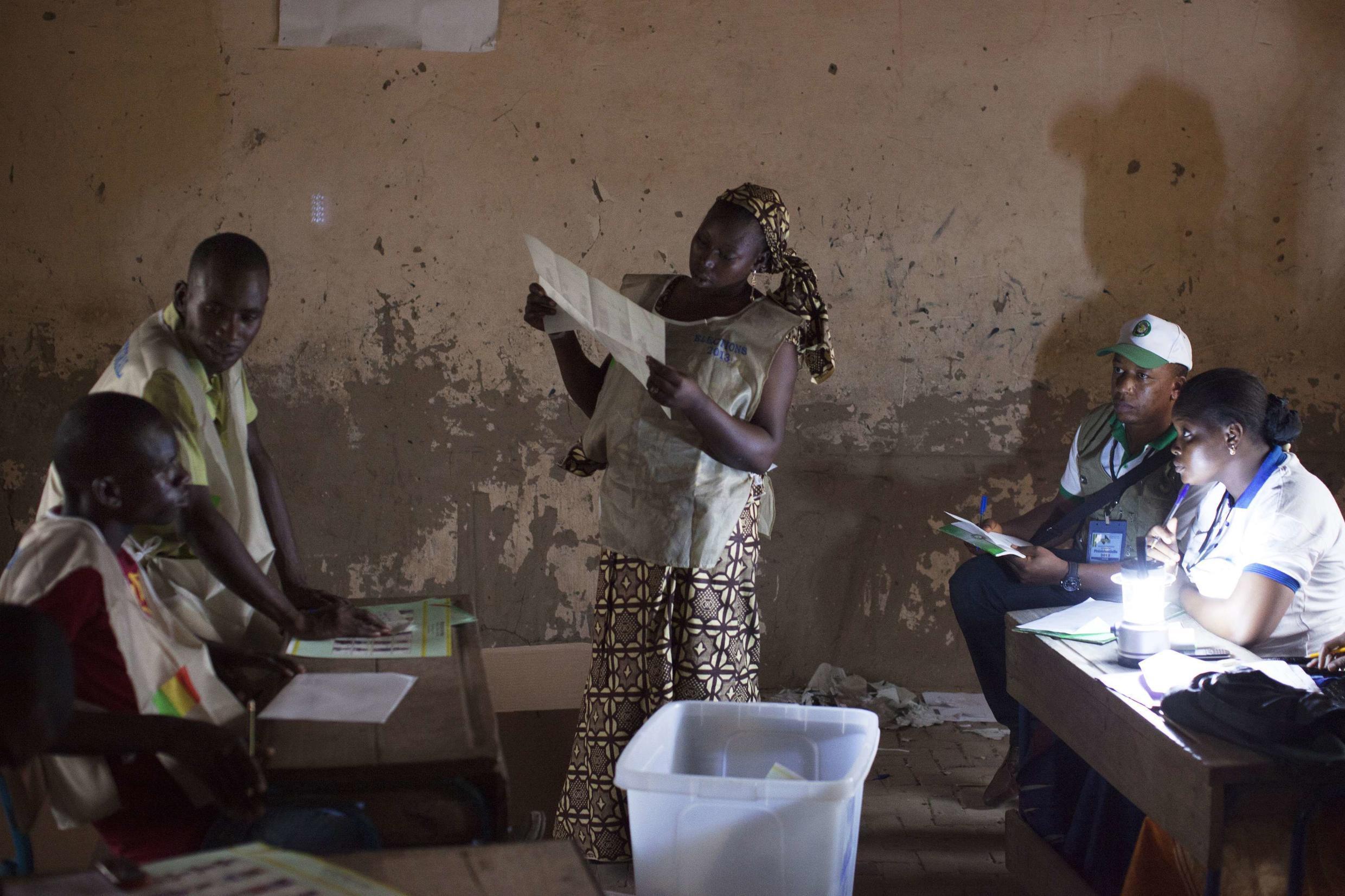 Poll workers count ballots after the end of voting in Mali's presidential elections in Timbuktu  28 July 2013.