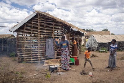 Inês Nambueda, 42, prepares food for her family in front of her unfinished shelter in Lianda IDP site. “My house in my village is still standing, I was willing to return there, but because of the volatile security situation, I decided to come to Lianda with my mother and my five children” she says.