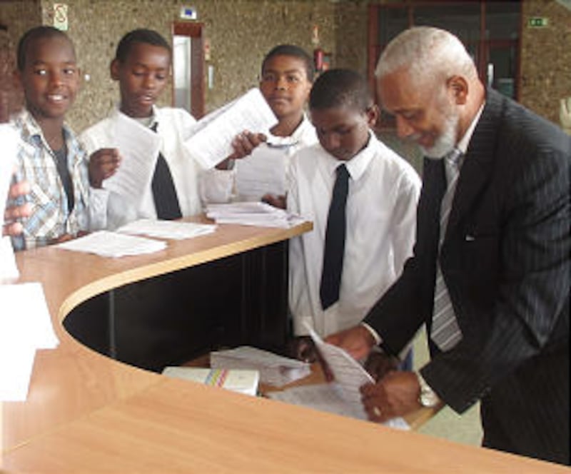 Young men folding programs with the help of Brother Antonio da Rosa