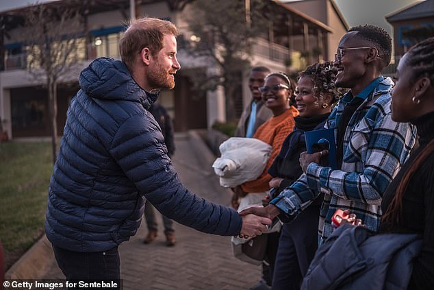 Prince Harry greets people at Sentebale's Mamohato Children's Centre in Lesotho yesterday